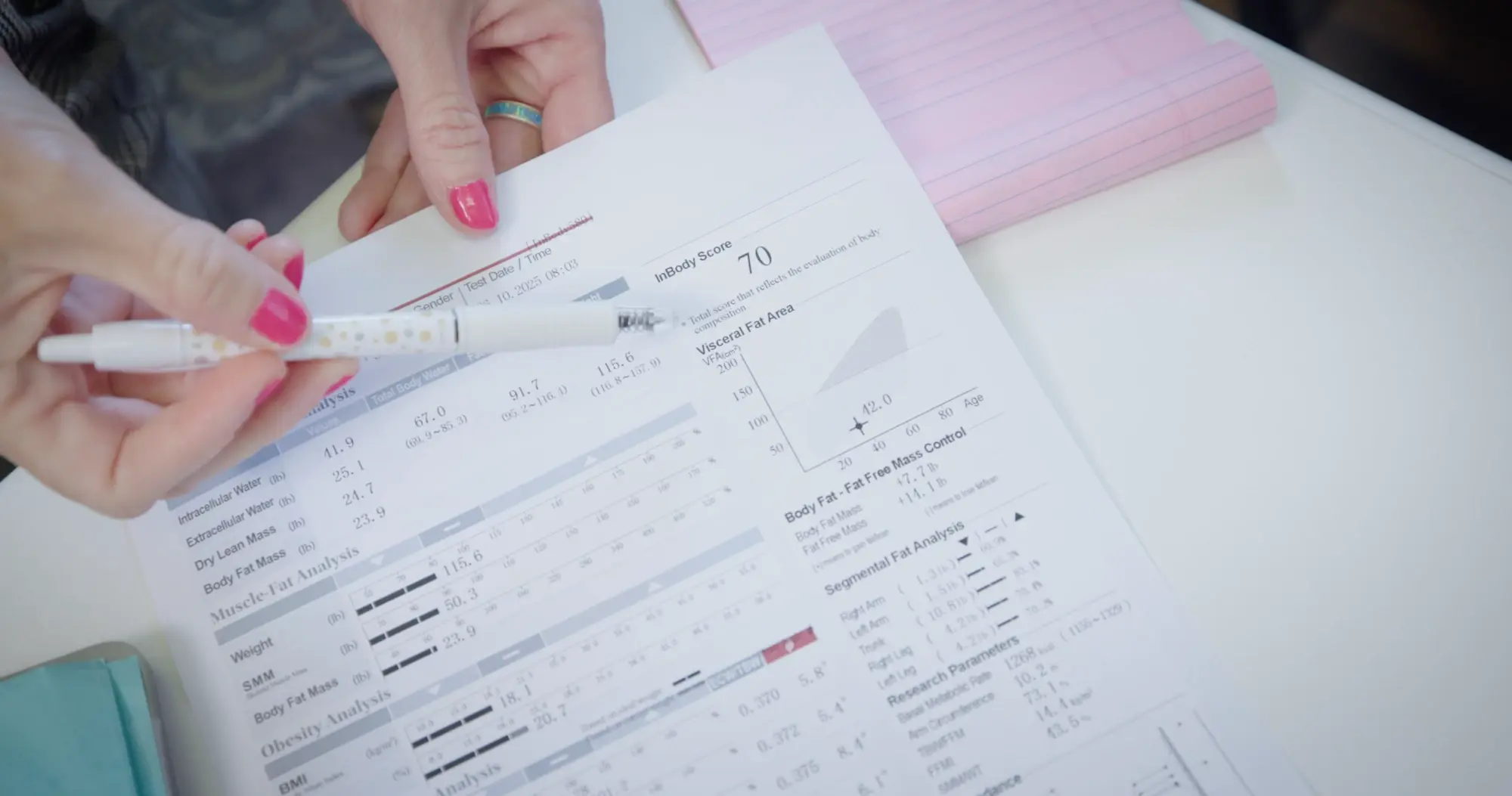 A clinician going through a printed body composition report with a patient